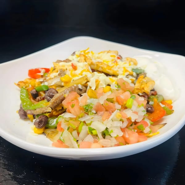 Los Amigos' fajita nachos with melted cheese, pico de gallo, and sour cream.